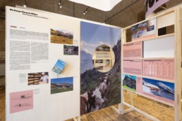Comprehensive exhibition graphic design by LWZ Studio for Toourism at Architekturzentrum Wien, showcasing large informational panels with alpine photography, infographics, and a circular peephole cutout. LWZ Design and Animation Vienna