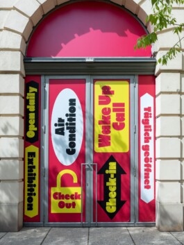 Bold typography and vinyl door signage designed by LWZ Studio for the Toourism exhibition at Architekturzentrum Wien, featuring bright red, yellow and black graphics. LWZ Design and Animation Vienna